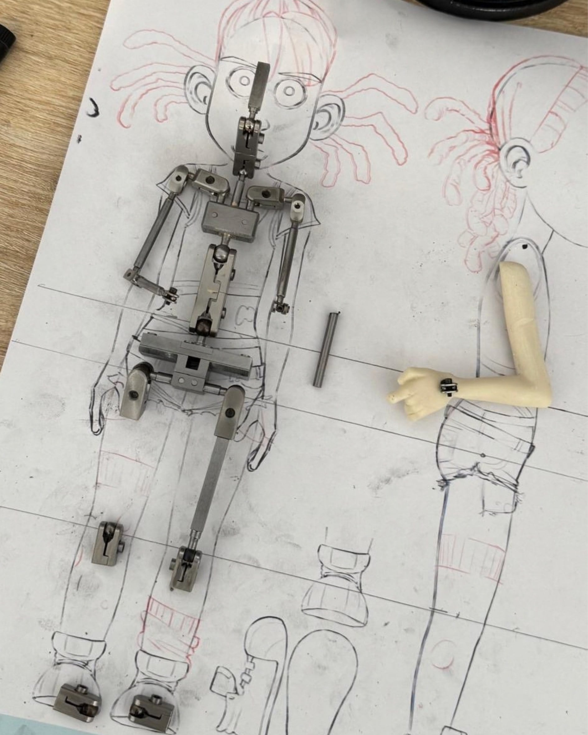 Zoé's metal armature lying on her construction drawings
